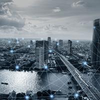 An aerial view of a bustling city, where modern skyscrapers rise above a shimmering river, interconnected by a network of light, symbolizing the flow of ideas and technology in an ever-evolving urban landscape.