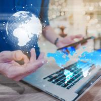 A professional navigating the digital landscape, balancing technology and global connections. The world map illuminates possibilities as innovative solutions unfold at their fingertips.